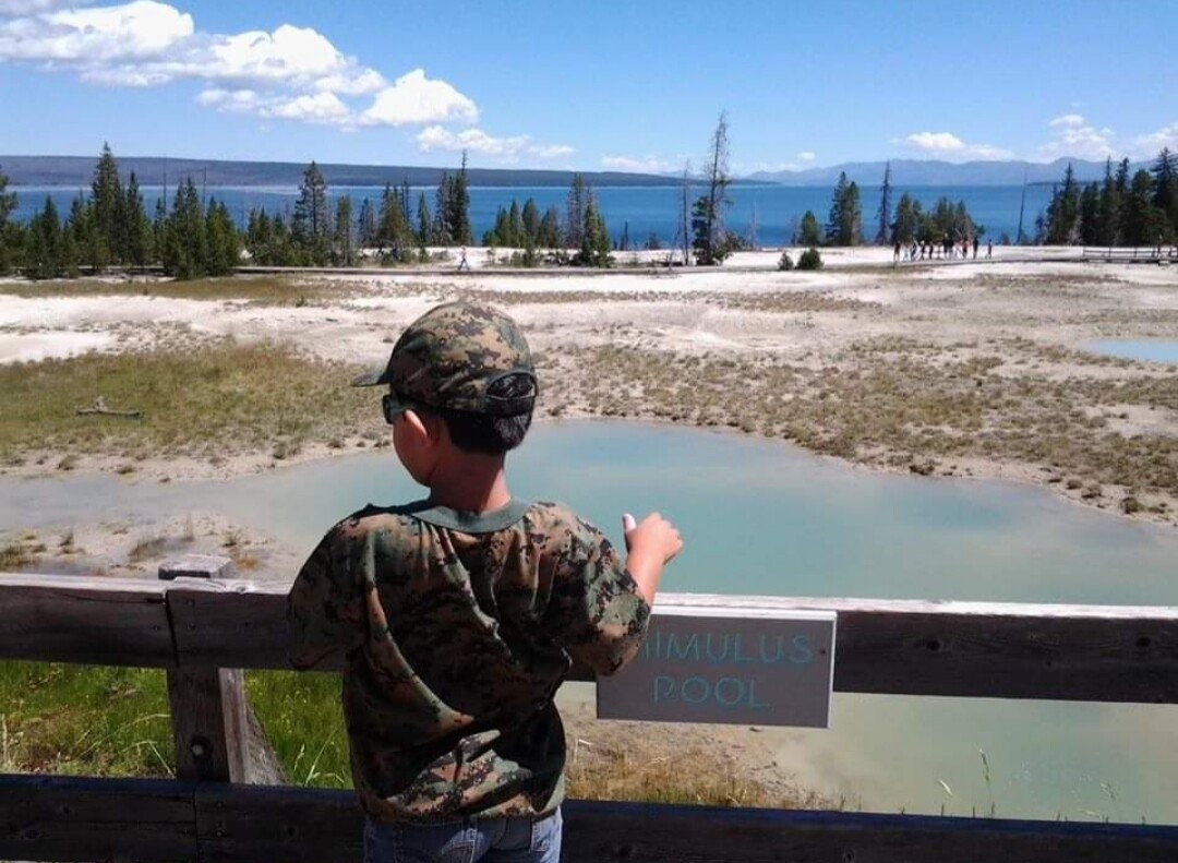 Son taking in the spectacle of Yellowstone Nationa