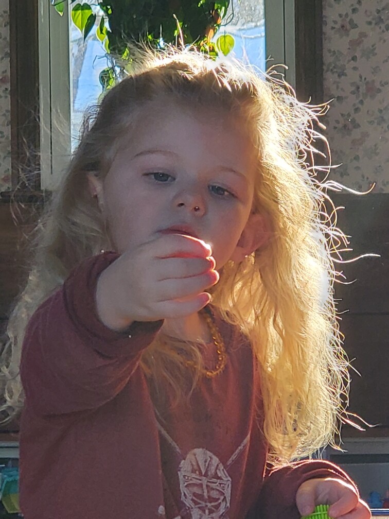 My granddaughter Haddie holding the light