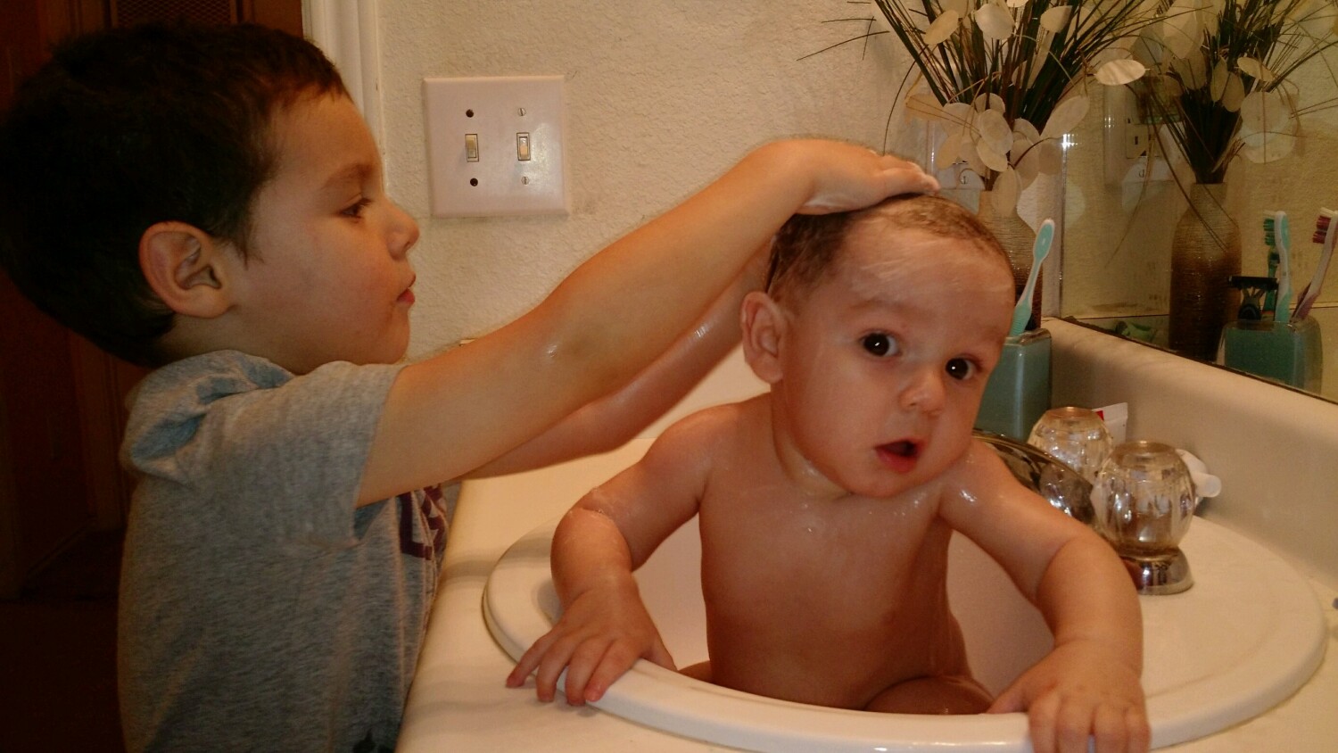 Brother giving brother a bath
