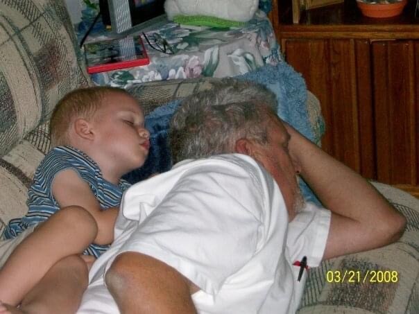 A boy and his pappaw taking a nap