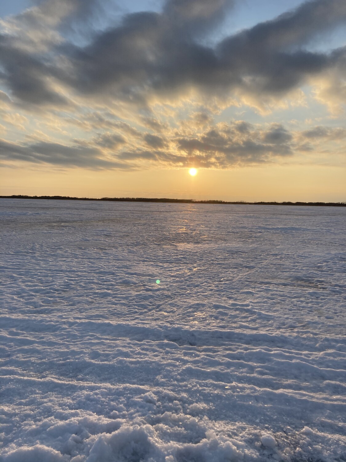 Sunset over a frozen lake